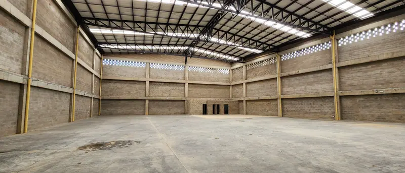 Interior de una bodega con cubierta metálica y muros de bloque